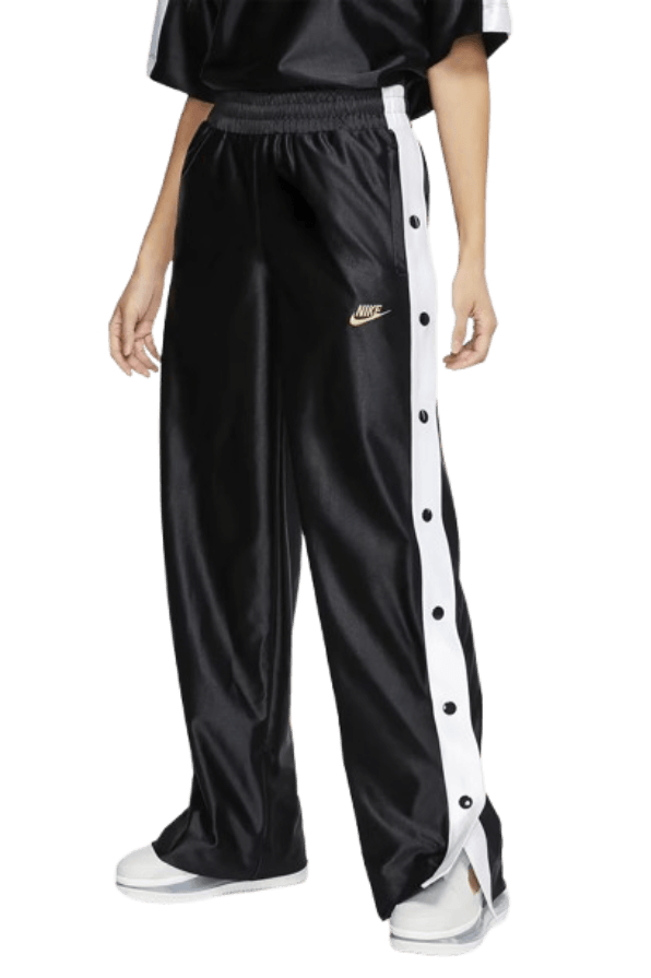 An iconic pair of black track pants with white side stripes and full-length snap buttons down the legs—the classic 90s tearaway pants made famous by courtside athletes and hip-hop stars.