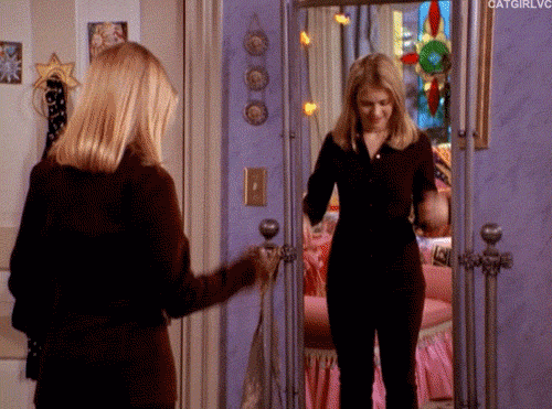 An animated GIF from Sabrina the Teenage Witch showing Sabrina Spellman (Melissa Joan Hart) spinning around in her bedroom as magical, glittering sparkles engulf her body to instantly swap her outfit.