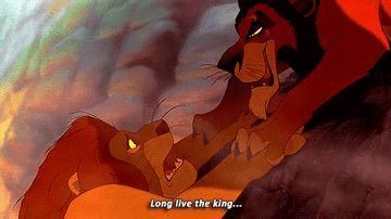 An animated GIF from Disney's The Lion King capturing Scar's evil grin and glowing yellow eyes as he utters 'Long live the king...' right before throwing Mufasa off the cliff.