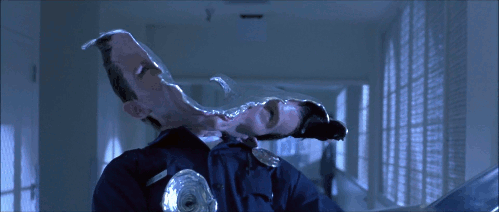 An animated GIF from Terminator 2: Judgment Day showing the liquid-metal T-1000 (Robert Patrick) getting shot through the head, morphing and reforming his metallic face back together in a groundbreaking 90s CGI flex.