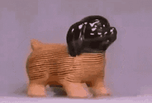 Animated Chia Pet Commercial Growth Animated GIF of a classic TV commercial time-lapse showing a terracotta puppy sprouting lush, green chia seed fur over several days.