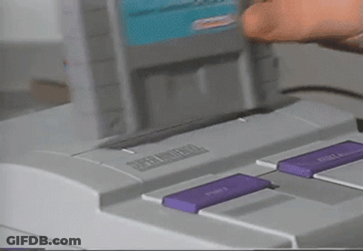 Super Nintendo Entertainment System putting cartridge in and turning on video