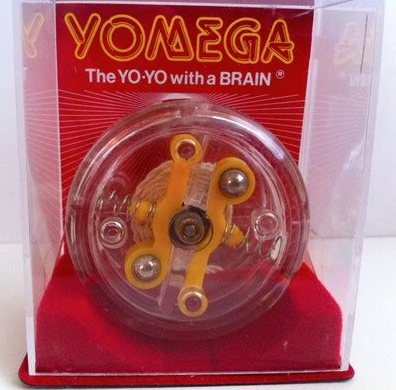 A static photo of a clear Yomega "Yo-Yo with a Brain" resting inside its original red-and-white retail display box.