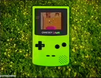 An animated GIF from a 90s Nintendo ad featuring a vibrant Kiwi green Game Boy Color floating in a field of lush grass, displaying 8-bit gameplay on its unlit reflective screen.