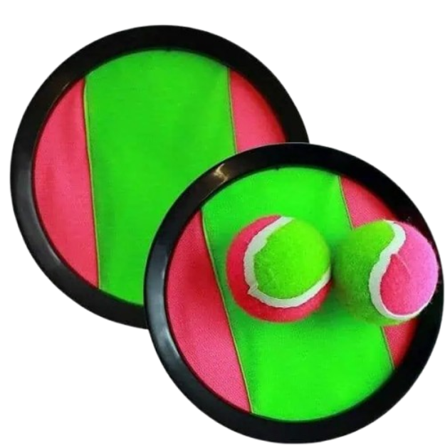A close-up image of the iconic 90s Scatch catch-and-toss set, featuring two round black plastic pads with neon green and pink velcro surfaces, and two classic green tennis balls with pink felt stripes, set against a static 90s-pattern background.