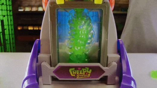 An animated GIF from a 90s Creepy Crawlers TV commercial showing green gel bubbling up inside the glowing chamber of the toy oven.