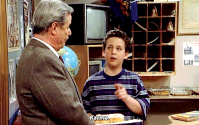 An animated GIF from Boy Meets World showing a young Cory Matthews (Ben Savage) wagging his finger while making a point to his neighbor and principal, Mr. Feeny (William Daniels), inside the school hallway.