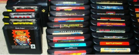 Sega Genesis Cartridge Stacks Organized collection of 16-bit Sega Genesis game cartridges displaying iconic spine labels for titles like Sonic The Hedgehog, Double Dragon, Vectorman, and Battletoads.
