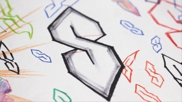 page of lined paper covered in hand-drawn "Cool S" (Super S) doodles, centered on a large 3D block-shaded version drawn in black marker.