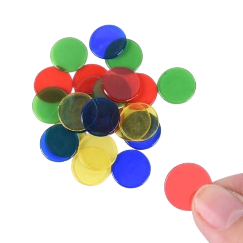 Bingo Overhead Transparency Chips Translucent primary-colored plastic counting chips scattered on a white surface, evoking the tactile nostalgia of elementary school math games and overhead projector lessons.