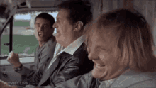 An animated GIF from Dumb and Dumber showing Lloyd Christmas (Jim Carrey), Harry Dunne (Jeff Daniels), and hitman Joe Mentalino driving in the Mutt Cutts van while screaming 'the most annoying sound in the world' at the top of their lungs.