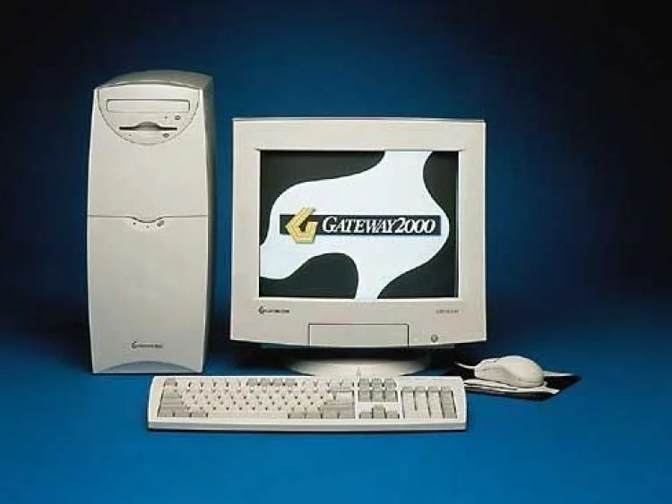 classic Gateway 2000 desktop computer set featuring a beige CRT monitor displaying the Gateway logo, a mid-tower PC case with the Windows logo, a keyboard, mouse, and the pixelated face of the Doom Guy protagonist from the classic 90s FPS video game.