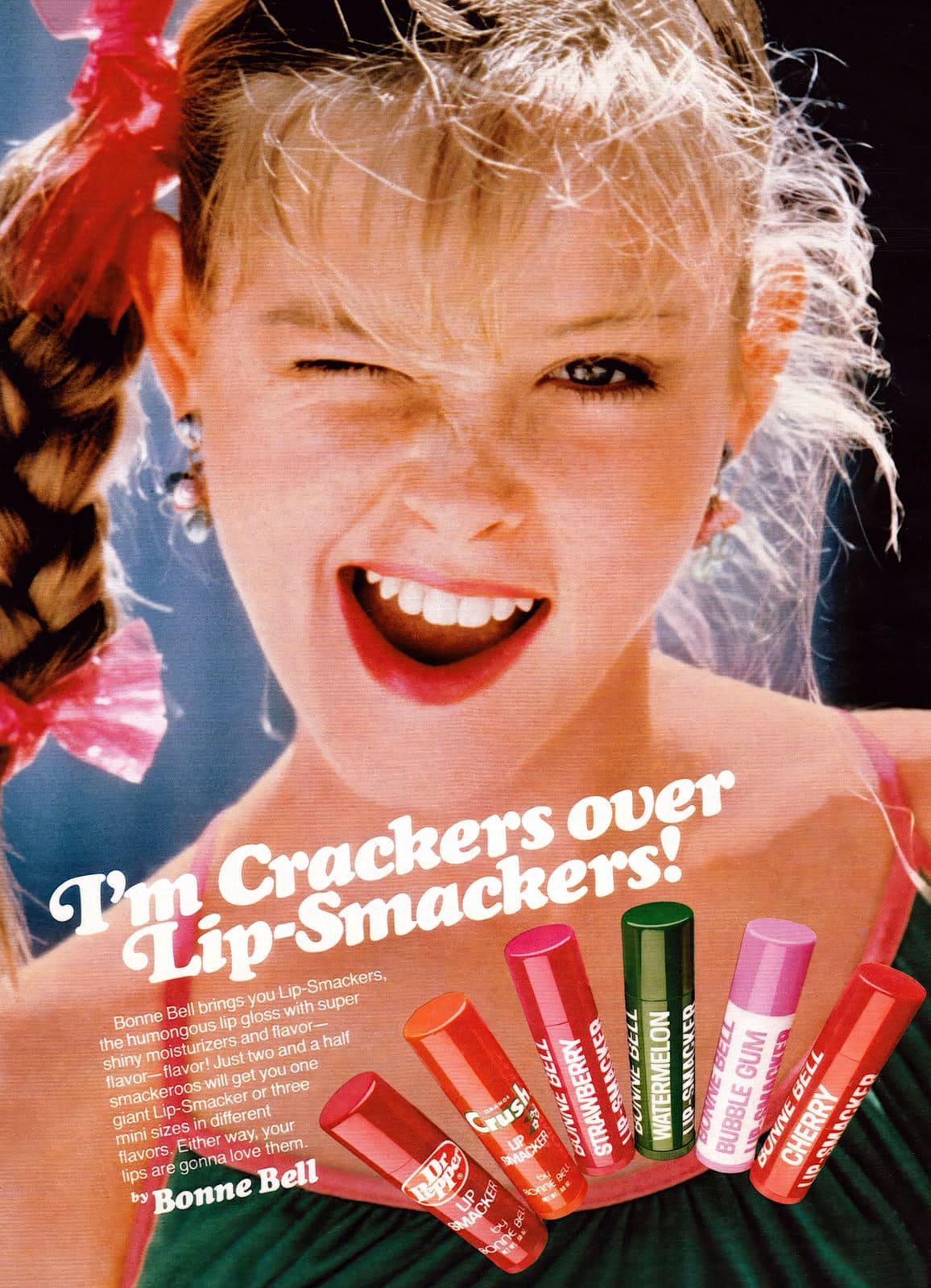 A retro Bonne Bell print ad featuring a teenage girl winking alongside giant jumbo-sized Lip-Smacker tubes in Dr Pepper, Orange Crush, Watermelon, and Bubble Gum flavors.