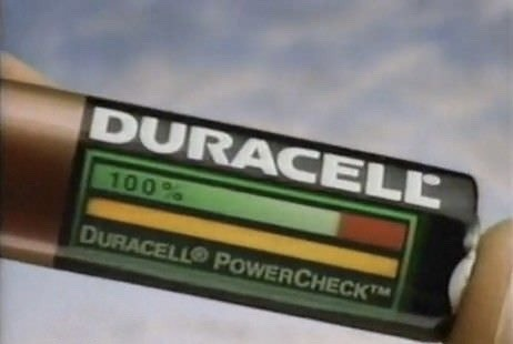 Duracell PowerCheck Battery Test Commercial 1990s Duracell AA battery showcasing the built-in PowerCheck strip being squeezed by two fingers to reveal a glowing yellow and green charge bar.