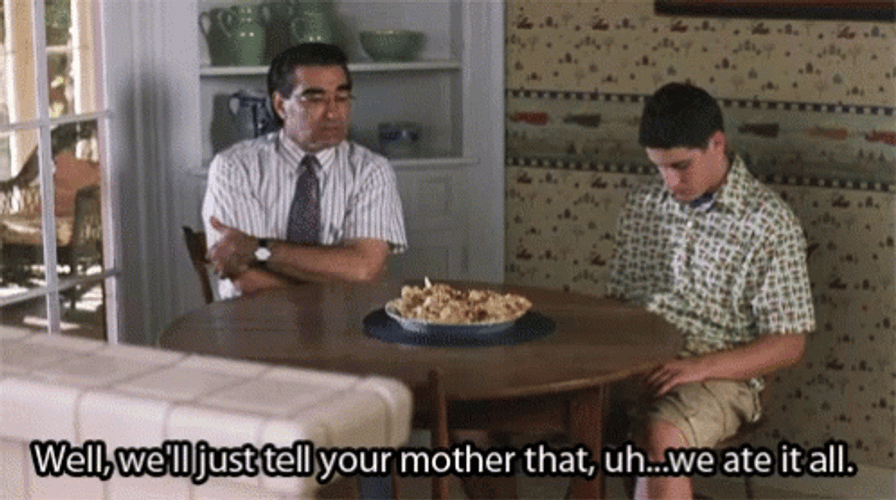 An animated GIF from American Pie featuring Jim's Dad (Eugene Levy) awkwardly reassuring a traumatized Jim (Jason Biggs) at the kitchen table with the subtitle: 'Well, we'll just tell your mother that, uh...we ate it all.'