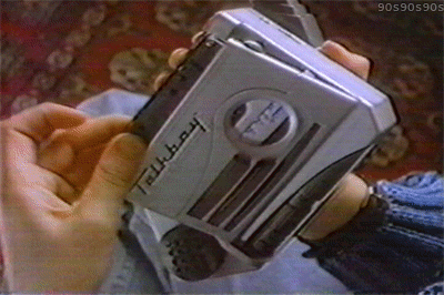 An animated GIF from a 90s Talkboy commercial showing hands operating the silver handheld tape deck and pressing buttons to manipulate voice pitch.