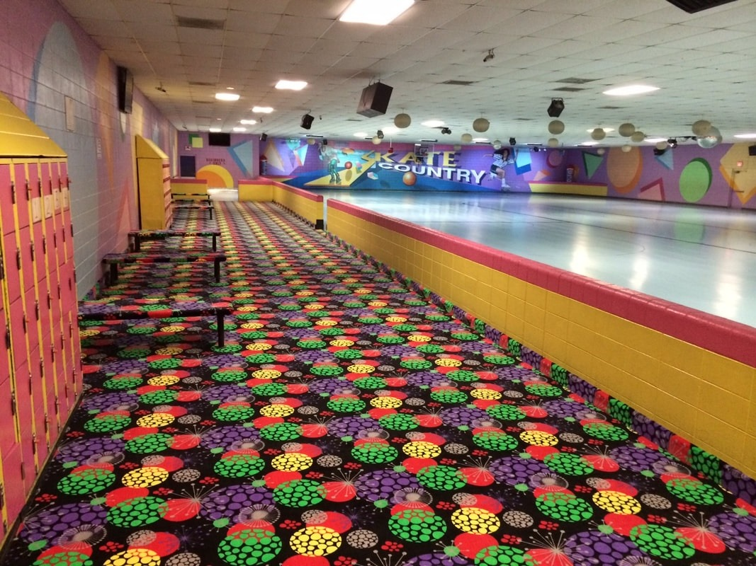 Skate Country Roller Rink Floor Retro 1990s roller skating rink interior featuring vibrant cosmic-pattern carpet, yellow bumper guard rails, and a polished hardwood floor under glowing ambient lights.