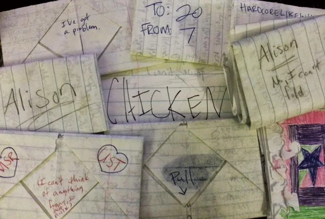 A collection of complexly folded notebook paper letters featuring "Pull" tabs, hearts, and elaborate tucks used to bypass the teacher's watchful eye during class.