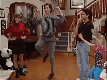 Animated GIF from Full House showing Danny Tanner in a striped button-down performing an energetic, quirky dance move in the living room as Aunt Becky and Uncle Jesse observe.
