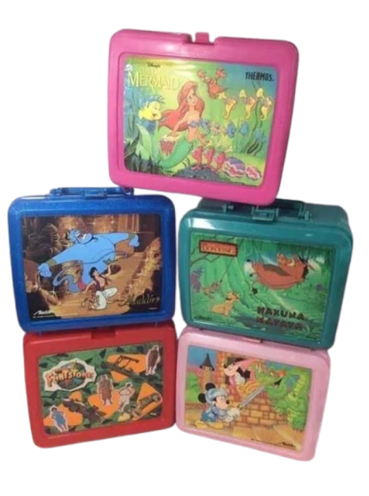 A stacked collection of vibrant 90s plastic lunchboxes with matching thermos art, featuring popular franchise designs like Disney's The Little Mermaid, Aladdin, The Lion King, and The Flintstones.