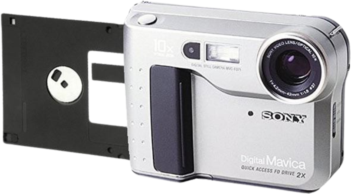 silver Sony Digital Mavica MVC-FD71 camera sitting next to a standard 3.5-inch black floppy disk, flexing its revolutionary direct-to-disk photo storage tech.
