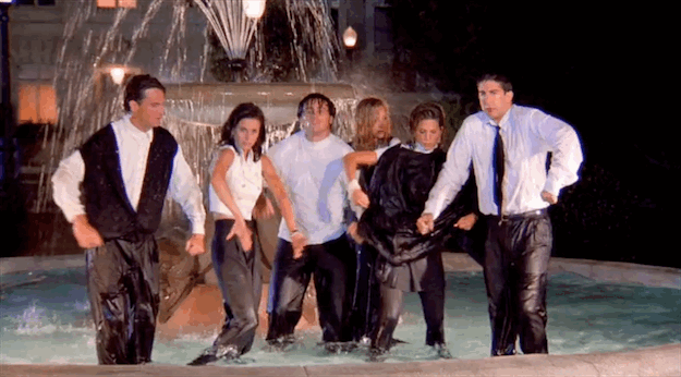 Animated GIF from the Friends opening credits showing Chandler, Monica, Joey, Phoebe, Rachel, and Ross dancing and flexing in the water in front of a fountain at night.