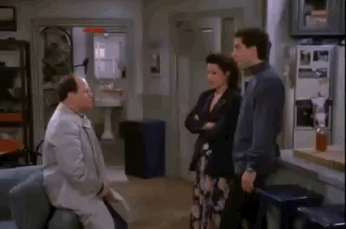 Animated GIF from Seinfeld showing Kramer sliding wildly through the front door into Jerry's apartment while George, Elaine, and Jerry stand in the room.